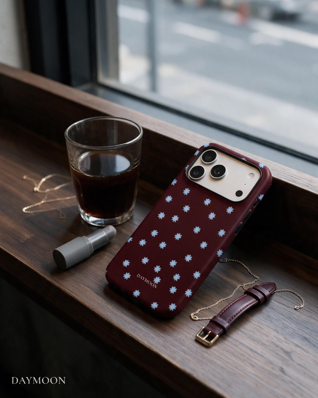 Wine Bloom phone case beside a coffee