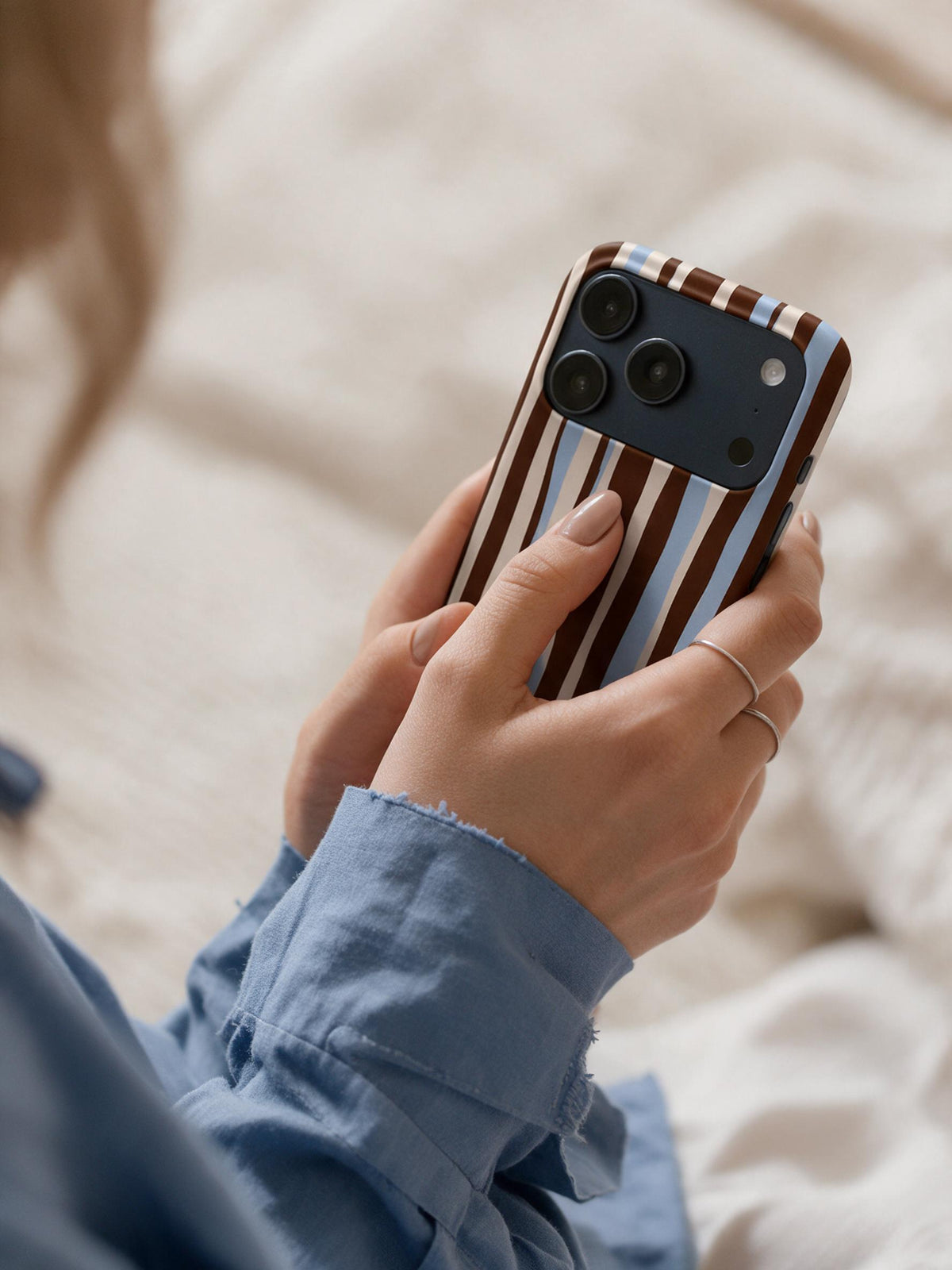 Cocoa Ribbon phone case in an everyday hand detail scene