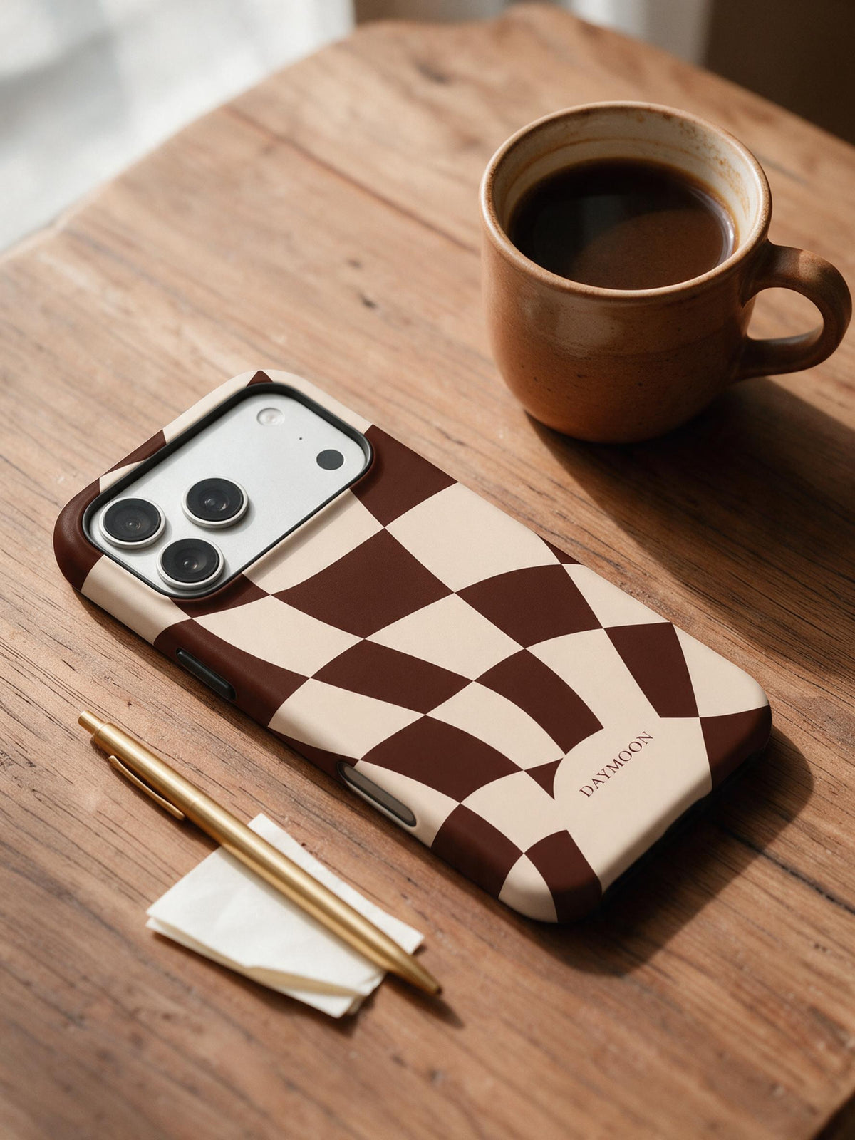 DAYMOON Cocoa Ripple phone case in an everyday still-life scene