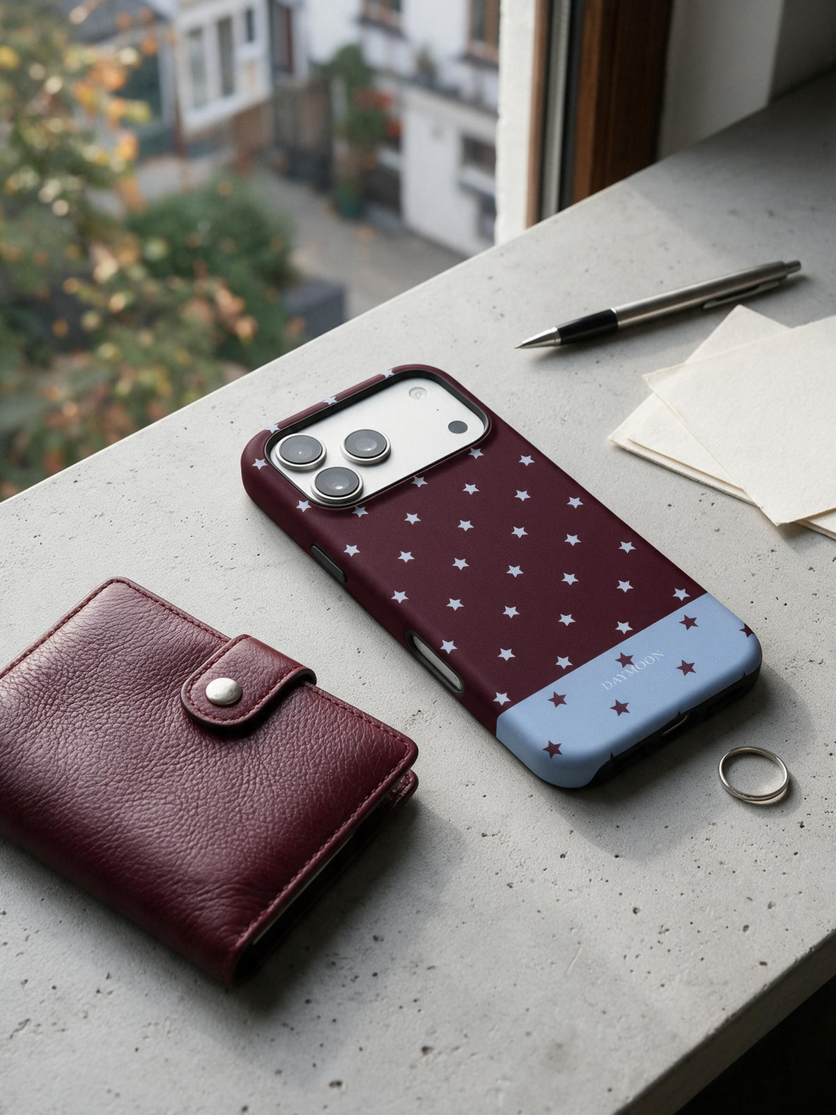 Burgundy Stars phone case in an everyday daily still life scene