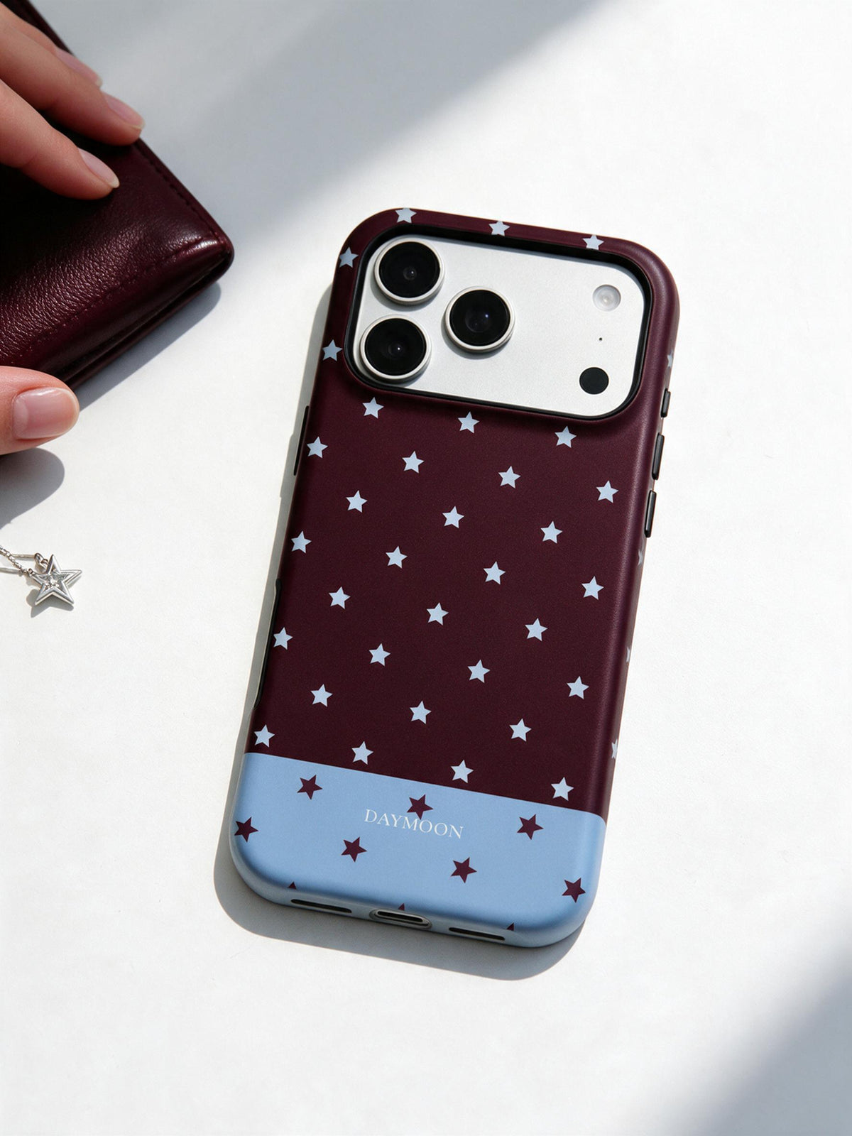 Burgundy Stars phone case in an everyday follow reference scene