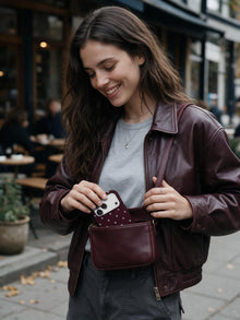 Burgundy Stars phone case in an everyday bag relation scene