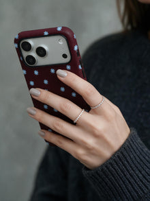 Wine Bloom phone case in an everyday hand detail scene