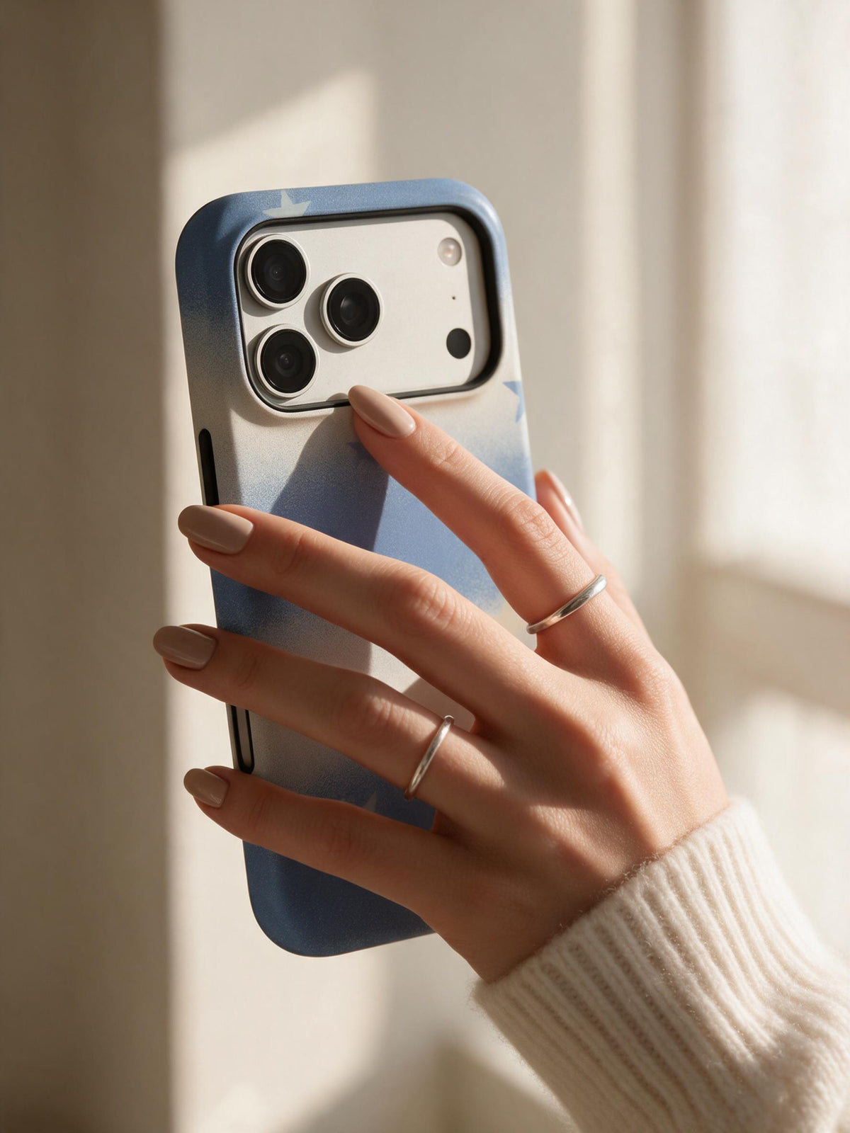 Drifting Stars phone case in an everyday hand detail scene